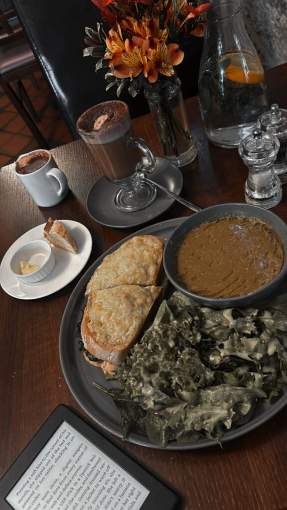 Solo dining experience in a Galway cafe with food, coffee, and a Kindle on the table, capturing the peaceful moments of enjoying a quiet evening.